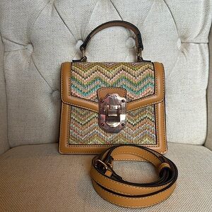 Also crossbody tan bag. Includes top handle and crossbody strap.